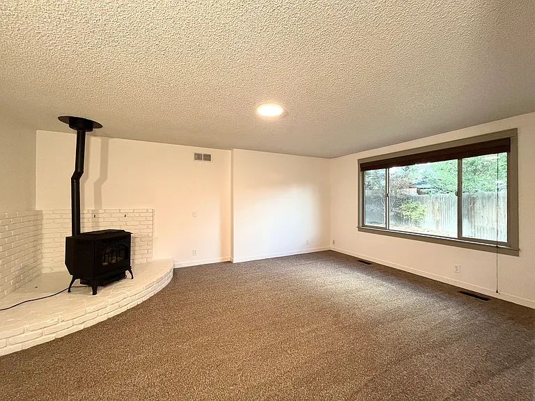 Comfortable living room with pellet stove for added ambiance.