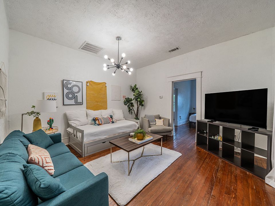 Stylish living room with a cozy sofa and large flat-screen TV.