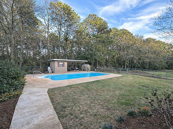 Fenced in backyard with pool