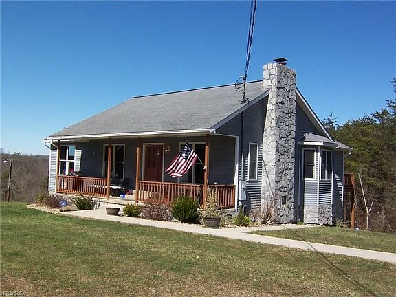 Right angle of home with stone chimney accents