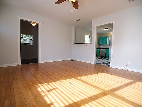 Spacious living room and beautiful original hardwood floors