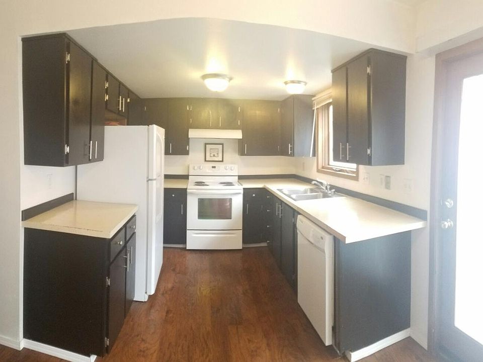 Cabinets have been newly stained espresso brown for a cozy k