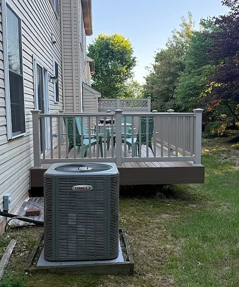 New A/C unit (2025) and tree-lined backyard