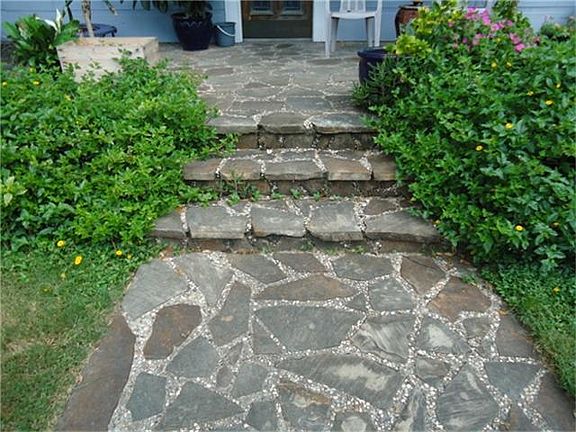 Stone steps welcome you to this charming home.