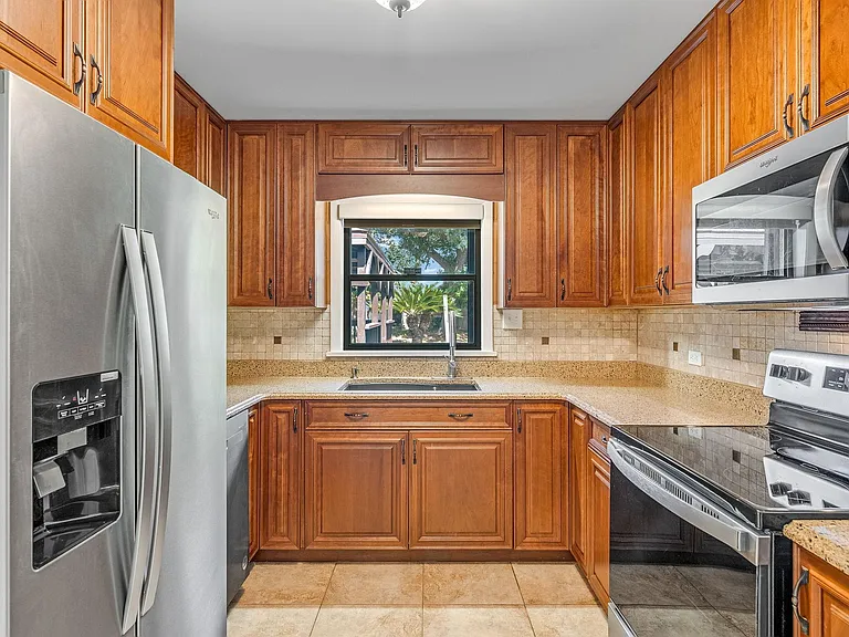 Kitchen with quartz countertops and all new stainless steel appliances.