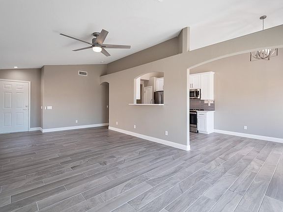 Spacious living room with new flooring and bar area.