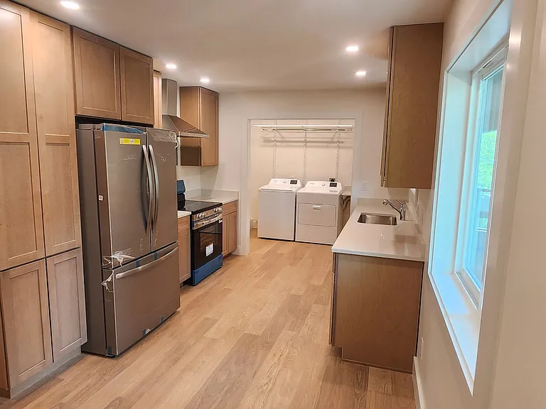 Kitchen, view from dining area through to laundy - all new appliances and cabinets