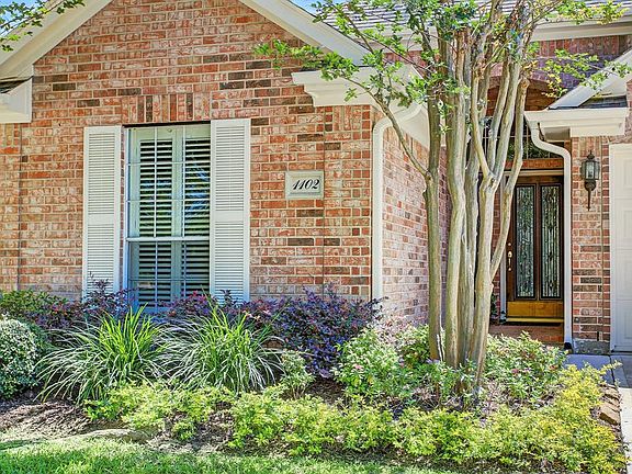 Lush landscaping with sprinkler system.