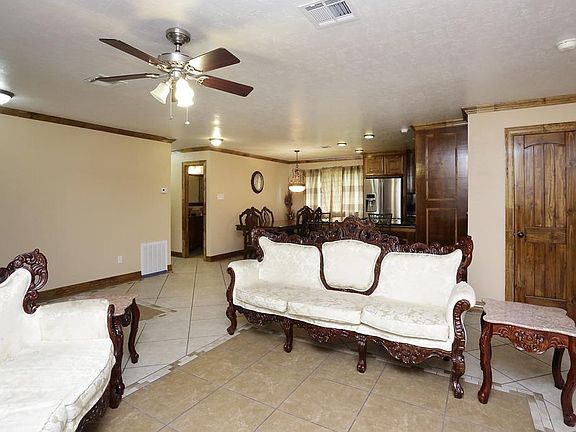The mud room is being used as a sitting area.  Notice that the crown molding is through out the house and even the mud room has it.