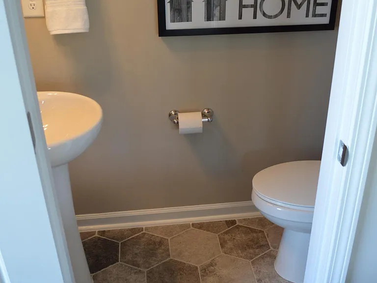 The powder room (as well as all the bathrooms) contain upgraded designer tiling.