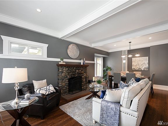 Main living room with beautiful fireplace.  These hardwood floors extend throughout the home!