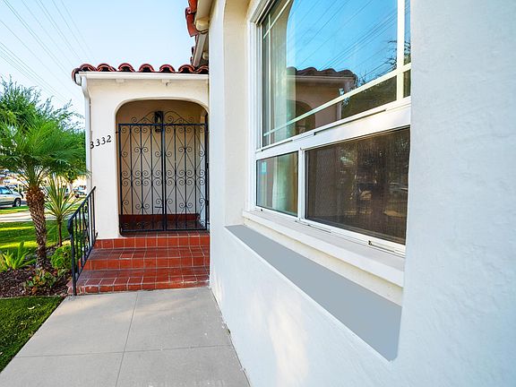 Adorable Spanish entry way with secure wrought iron gate
