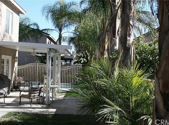 The backyard shows the landscaping has been kept with professional care. And the permitted, attached patio cover is perfect for barbecues.