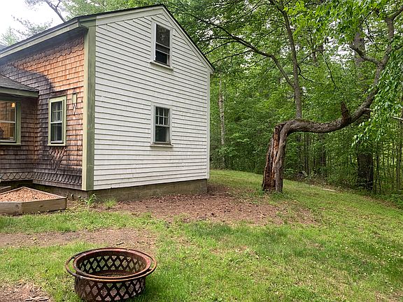 Back of house. Fire pit. Attic window above. Bigger bedroom windows. Bath room window.