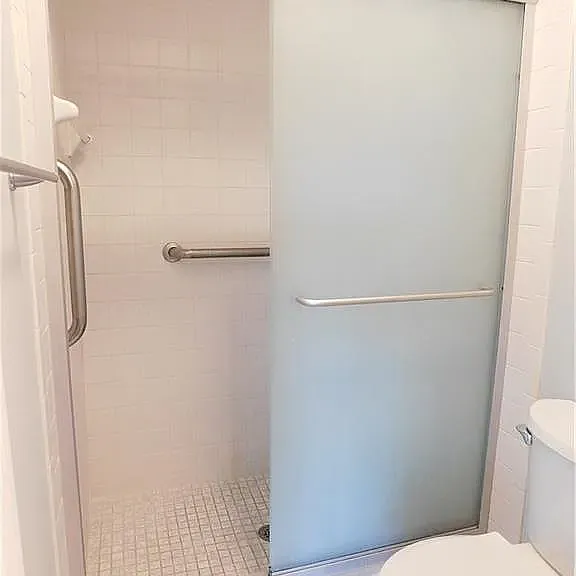 Private shower and toilet area to left of sink.