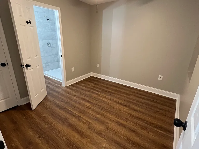 Bedroom 1 with Modern Fan and an in-room Bathroom 1