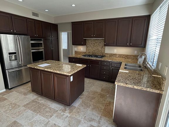 Remodeled kitchen with granite countertops and center island.