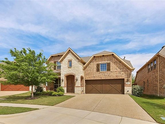 YOU'LL LOVE THE BRICK & STONE FACADE OF THIS HOME & THERE'S EVEN A COZY FRONT PORCH!