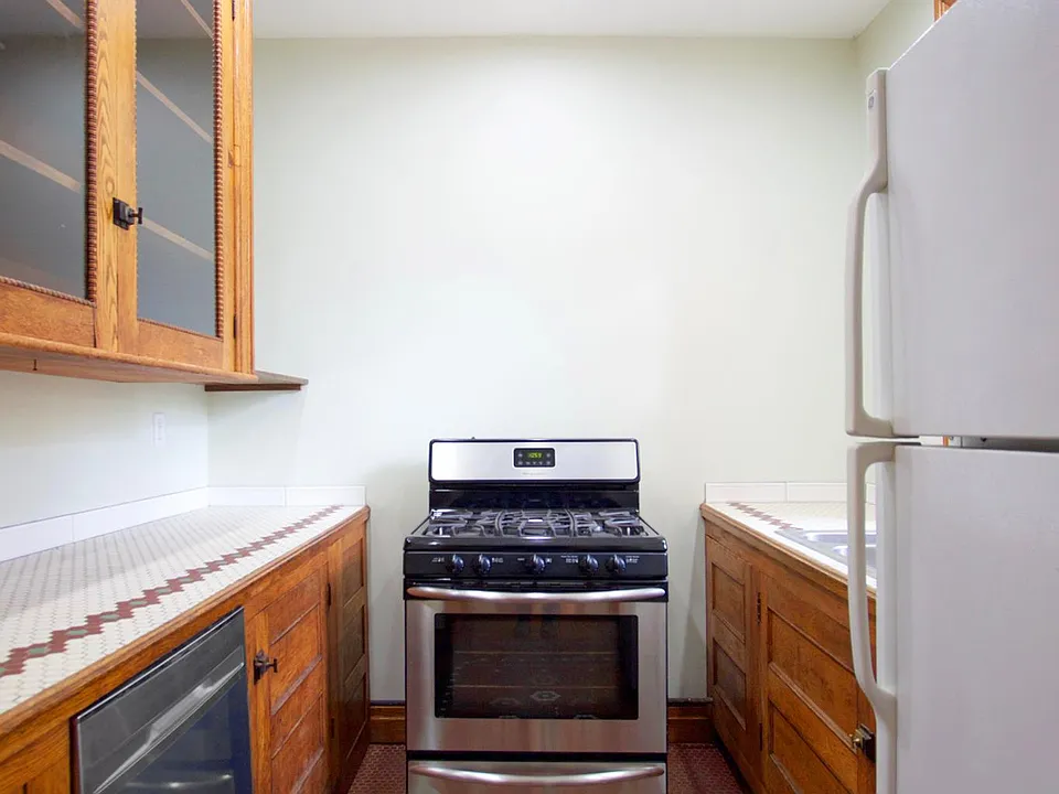 Galley kitchen with stove, fridge and dishwasher
