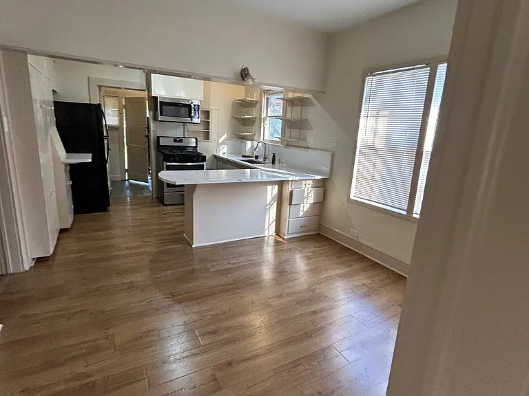 Photo taken from living room door way. Space for dining room table.
