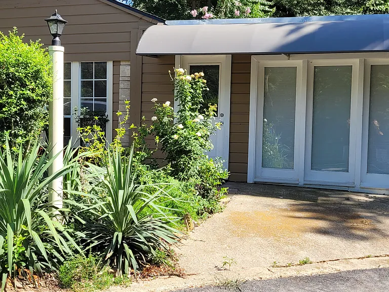 Front entry. Reserved parking right to the right.This side faces the north, so no direct sunlight in front windows. Front room usually used for a living room.