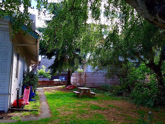large yard with picnic bench