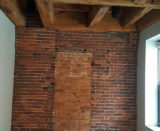 Bright living area with brick and beam charm!