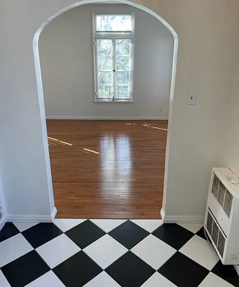 Light-filled kitchen/dining of 203 looks into windows on two walls of main room