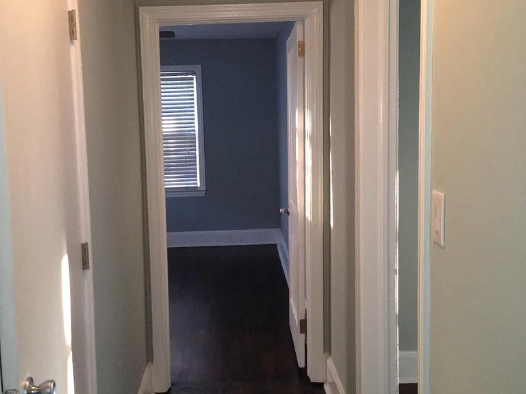 Hallway between two upfront bedrooms