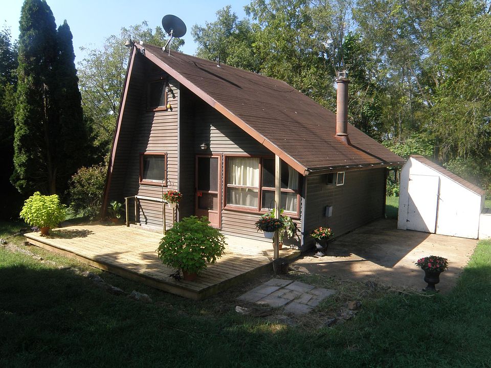 Outside of home, deck, grill pavers and concrete setting area to rear of home