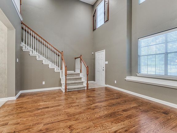 Brand new hardwood floors, inviting living area with soaring ceilings