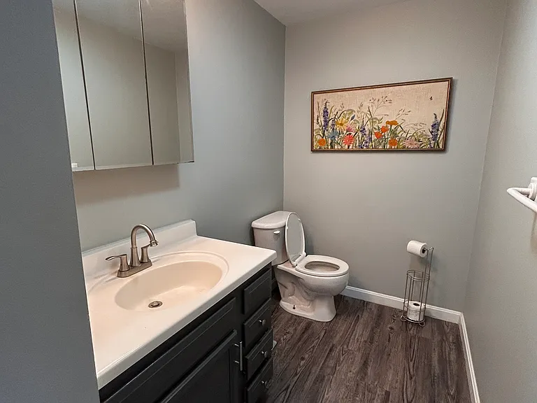 Downstairs half bath with updated hardware, paint and flooring