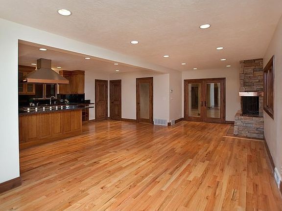 View of open dining room w/ fireplace looking into kitchen