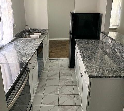 Galley style kitchen with granite countertops