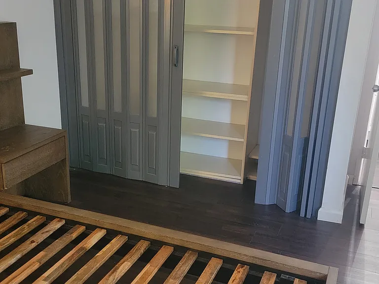 Built-in closet featuring shelving and a hanging bar