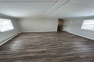 Living Room and front door. Also new mini-blinds throughout the home.
