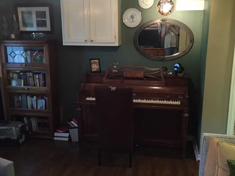 An even older photo of the living area (Rm #1). The front door is to the left and the kitchen to the right. Apt. is unfurnished has been repainted a lighter color as shown in other pics and has a brand new lighter color, improved flooring.