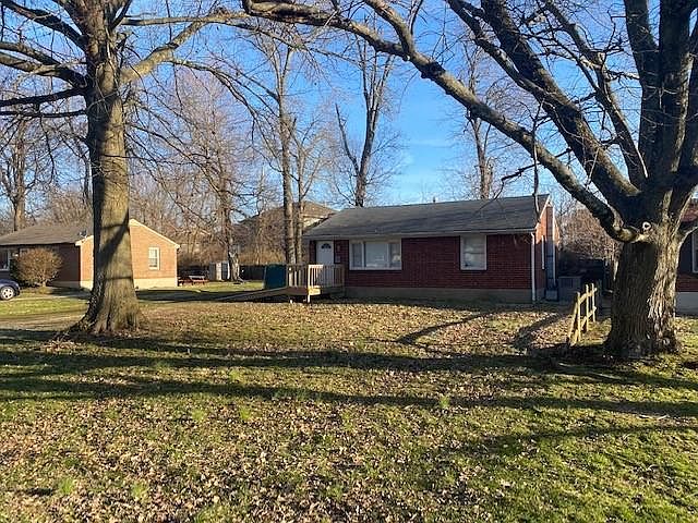 Front house and yard with wheelchair ramp.