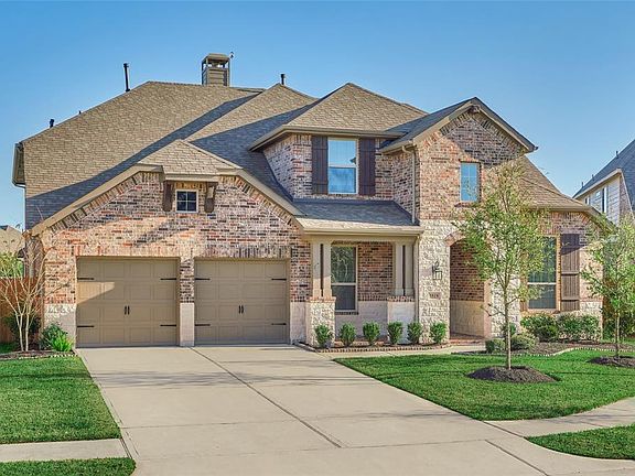 The home has an inviting brick and stone elevation with a covered front and rear porch!