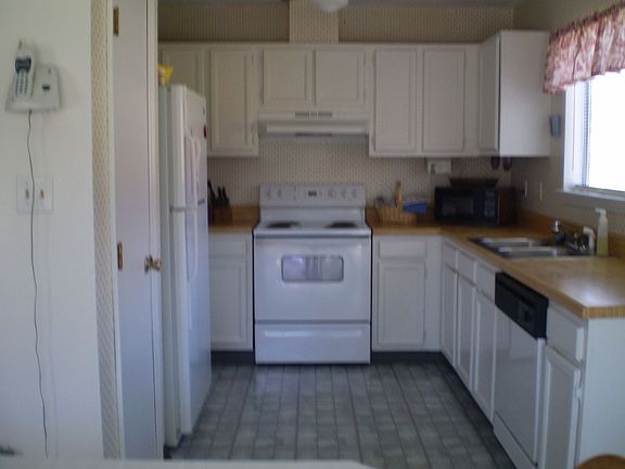 Freshly painted cabinets in bright and airy kitchen.