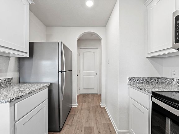 The kitchen of the Rio Grande has white wood cabinets.