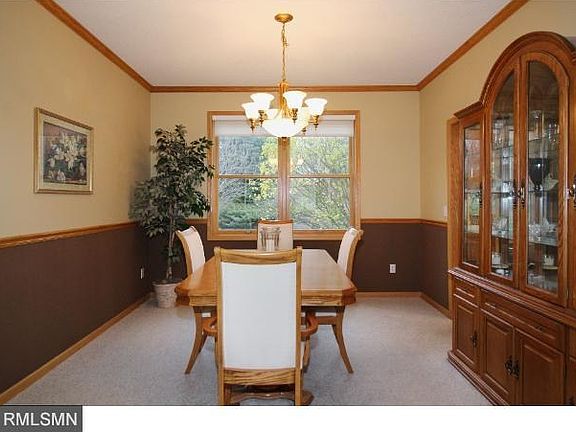 Bright and cheery kitchen with center island, stainless steel appliances which include convection oven and warming oven, wood floors, and is open to the family room