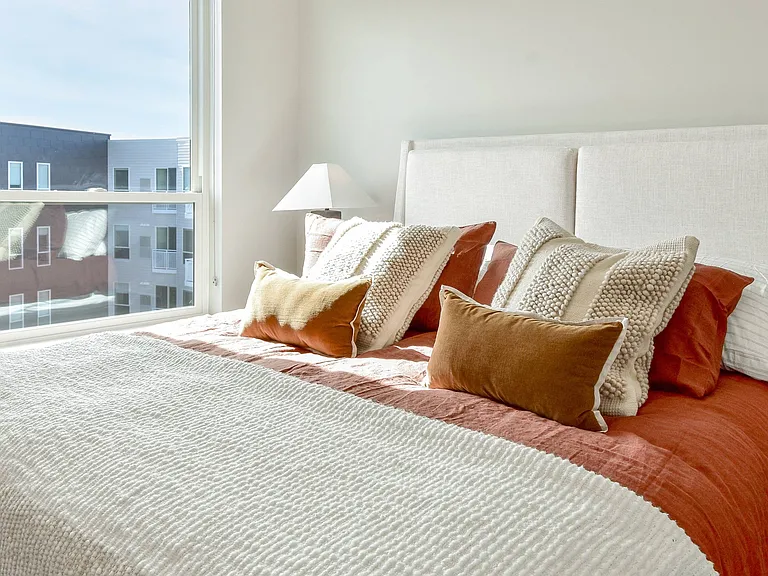 This cozy bedroom is a haven for sweet dreams at The Hallon luxury apartments in Hopkins, MN