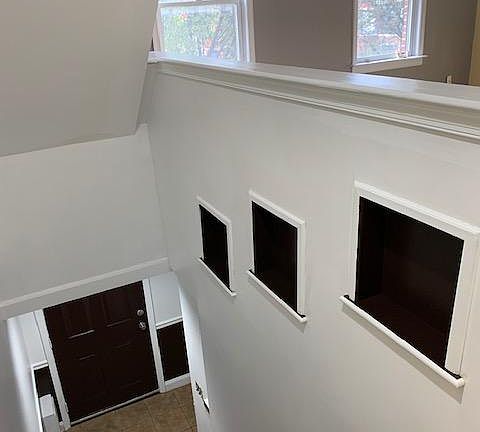 Entrance door staircase to living room.
