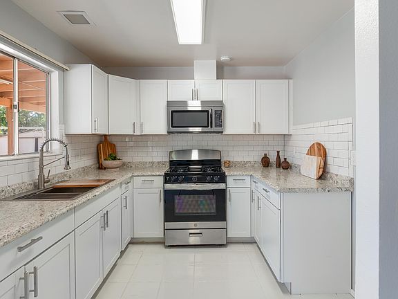Brand new kitchen with new stainless steel appliances, huge industrial sink and subway tile backsplash