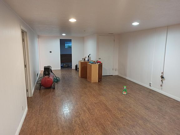 other end of living room, upper cabinets that will be installed in kitchen