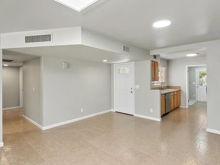 View of kitchen/dining area/front door/hall to bedrooms