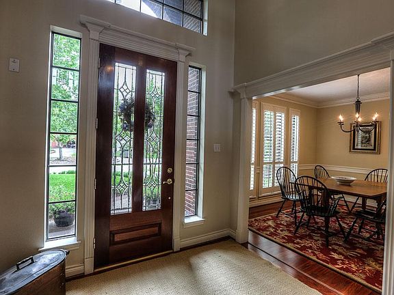 Beveled glass double doors. Crown molding and custom trim work is found though-out this lovely custo