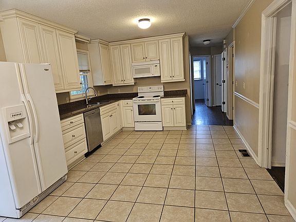 Kitchen with granite counters, and fridge!
