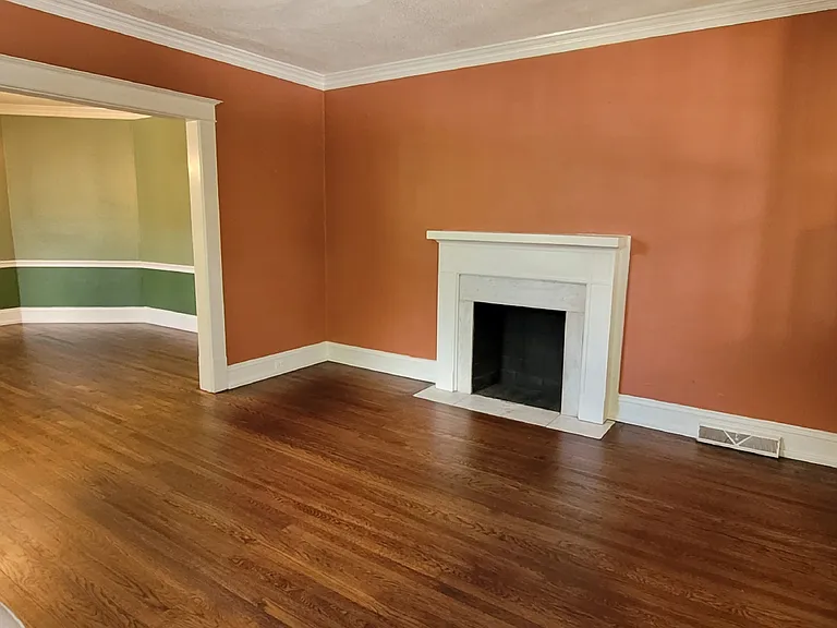 Original fireplaces in living room and two bedrooms, now for decorative purposes, add to historic charm.